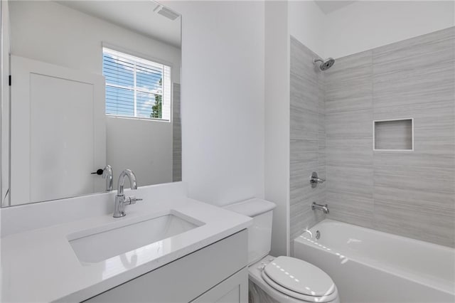 full bathroom with vanity, toilet, and tiled shower / bath