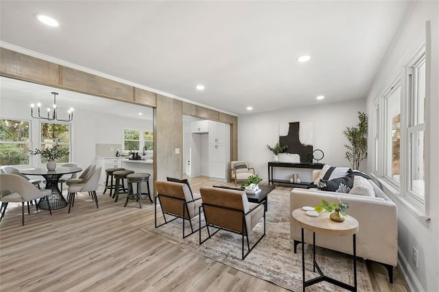 living room with light hardwood / wood-style flooring and a notable chandelier