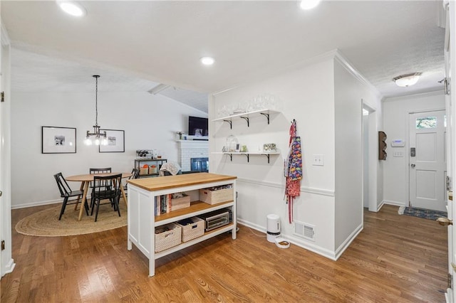 190 Windflower Trce, Roswell, GA 30075 - kitchen with wood finished floors, open shelves, ornamental molding, vaulted ceiling, and a brick fireplace