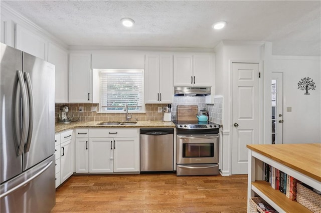 190 Windflower Trce, Roswell, GA 30075 - kitchen with stainless steel appliances, under cabinet range hood, white cabinets, light stone counters, and light wood-style flooring