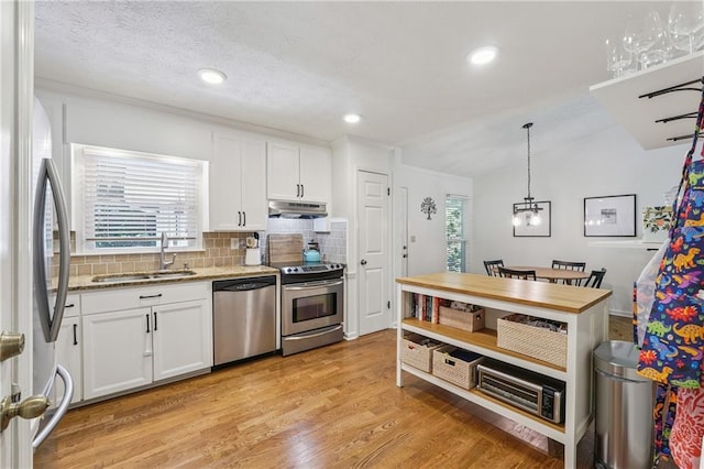 190 Windflower Trce, Roswell, GA 30075 - kitchen featuring stainless steel appliances, decorative backsplash, white cabinets, light stone counters, and light wood-style floors