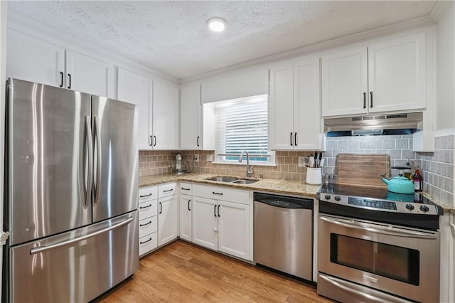 190 Windflower Trce, Roswell, GA 30075 - kitchen featuring appliances with stainless steel finishes, under cabinet range hood, white cabinets, light stone countertops, and a textured ceiling