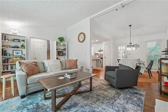 190 Windflower Trce, Roswell, GA 30075 - living room featuring wood finished floors, crown molding, a chandelier, and a textured ceiling