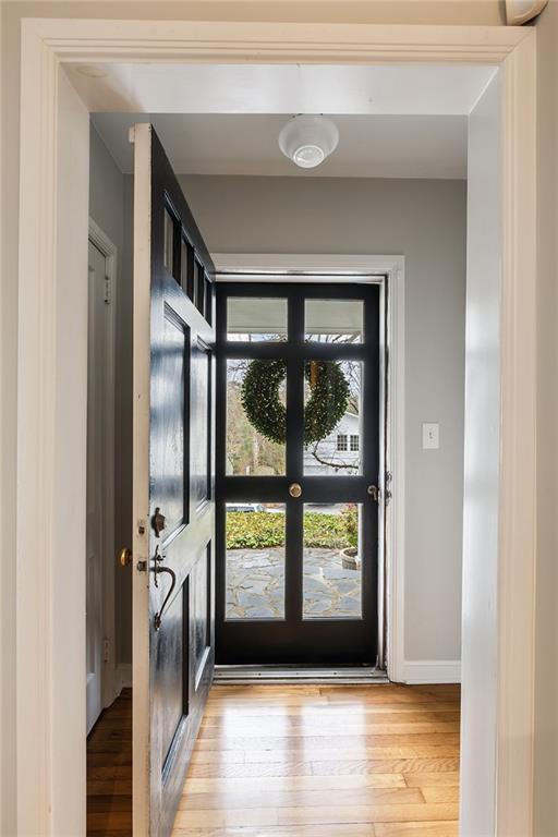 entryway featuring light wood-style flooring and baseboards