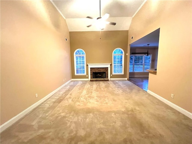 6745 Fairfield Trce, Suwanee, GA 30024 - unfurnished living room featuring carpet flooring, a ceiling fan, baseboards, a fireplace, and high vaulted ceiling