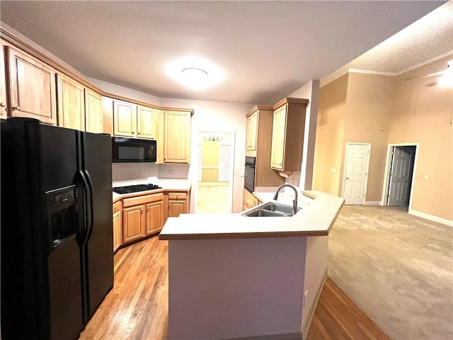 6745 Fairfield Trce, Suwanee, GA 30024 - kitchen featuring black appliances, a sink, a peninsula, light countertops, and baseboards