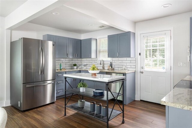 1258 Campbellton Rd SW, Atlanta, GA 30310 - kitchen featuring stainless steel appliances, backsplash, light stone countertops, dark wood-style flooring, and recessed lighting