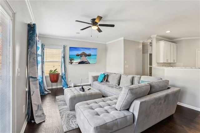 living area featuring dark wood-style floors, baseboards, ceiling fan, and crown molding