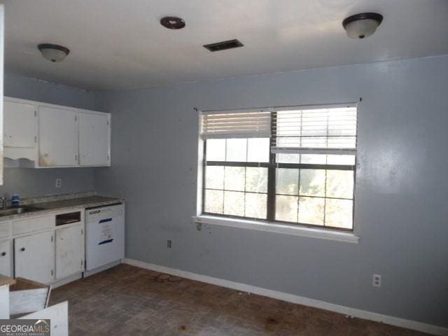 kitchen featuring sink, dishwasher, and white cabinets