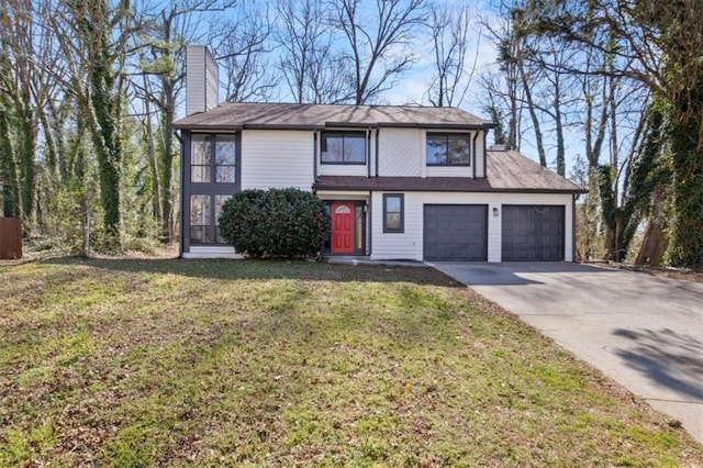 traditional home with a front yard, concrete driveway, a chimney, and an attached garage