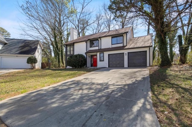 view of front of house featuring a garage, driveway, a chimney, and a front yard