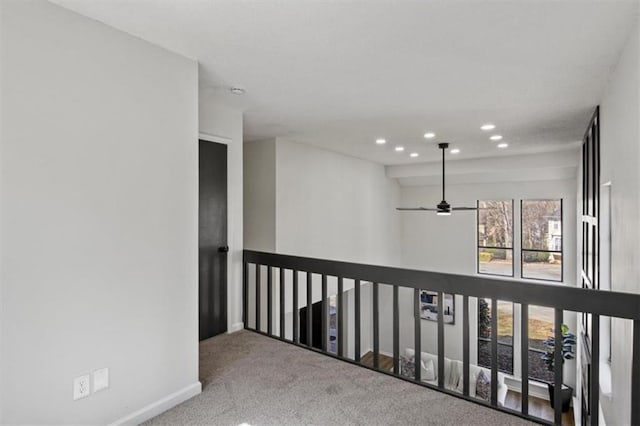 hall featuring carpet, baseboards, and recessed lighting