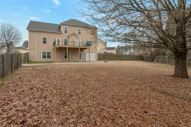 rear view of house featuring a garage and a patio area