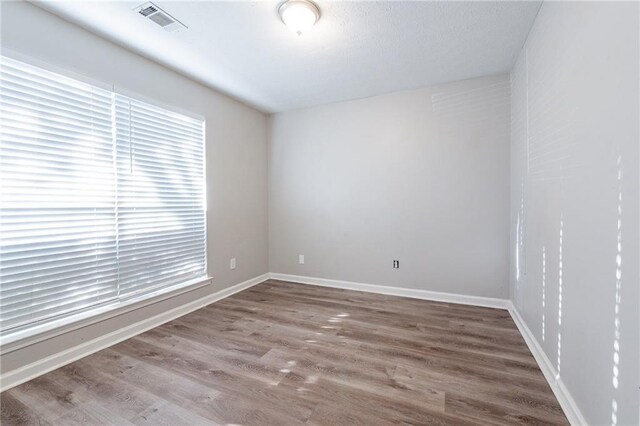 spare room featuring hardwood / wood-style flooring