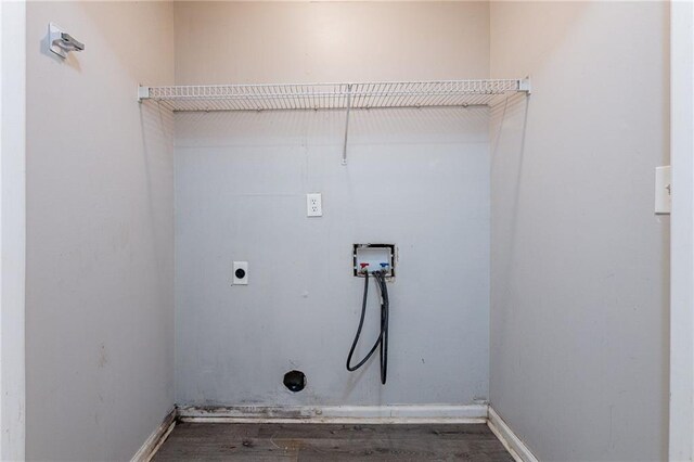 washroom with dark wood-type flooring, washer hookup, and hookup for an electric dryer