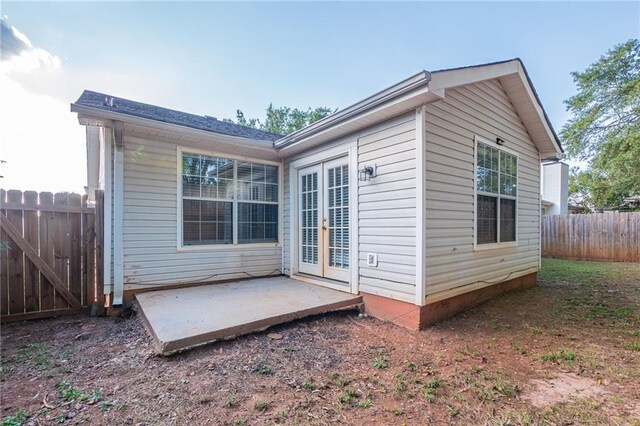 rear view of property with french doors and a patio area