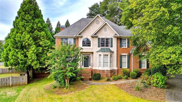 colonial home featuring a front yard