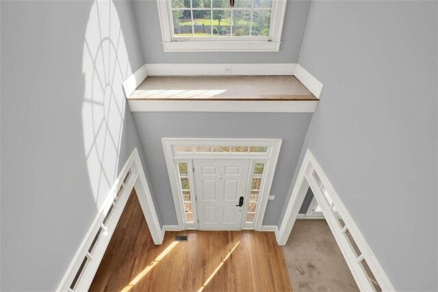 dining room with crown molding, an inviting chandelier, and hardwood / wood-style flooring