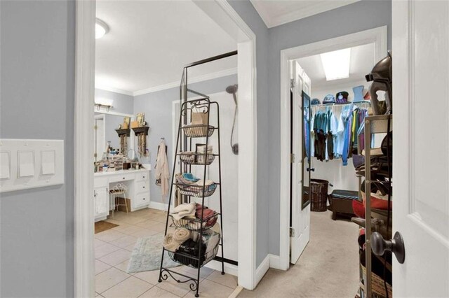 hall featuring hardwood / wood-style flooring, ornamental molding, and a notable chandelier