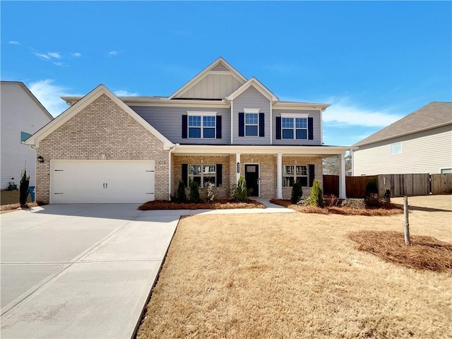 craftsman inspired home with fence, driveway, an attached garage, board and batten siding, and brick siding