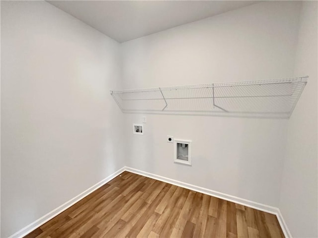 laundry room with washer hookup, wood finished floors, baseboards, hookup for an electric dryer, and laundry area