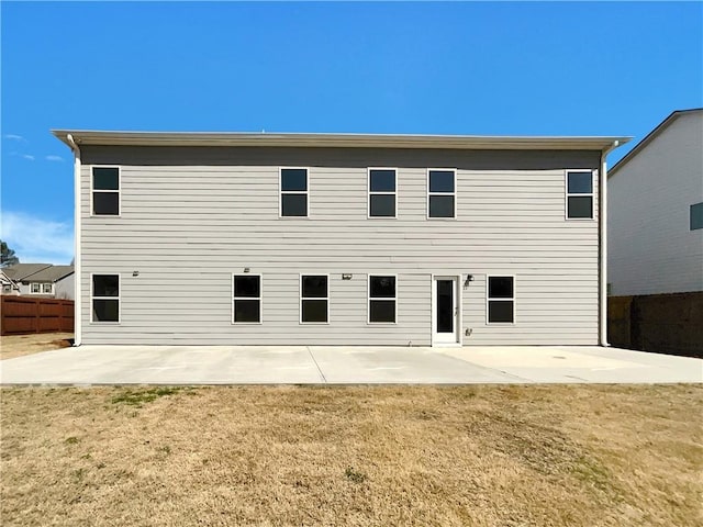 back of property featuring a patio, a yard, and fence