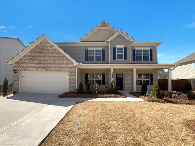 craftsman house with a garage, brick siding, board and batten siding, and concrete driveway