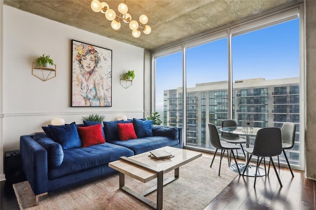 living room featuring expansive windows, wood finished floors, and a chandelier