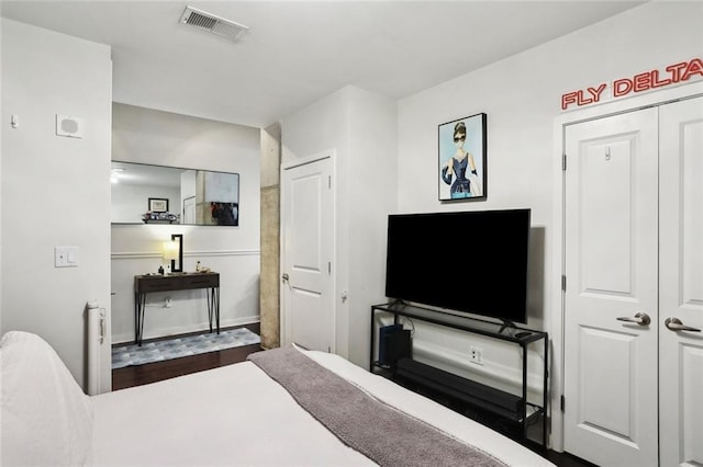 bedroom featuring radiator and baseboards