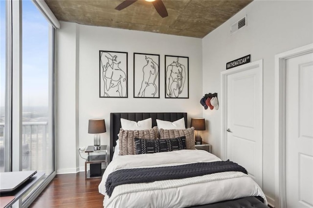 bedroom with dark wood finished floors, baseboards, and a ceiling fan