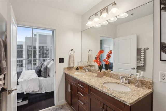 full bath featuring double vanity and connected bathroom