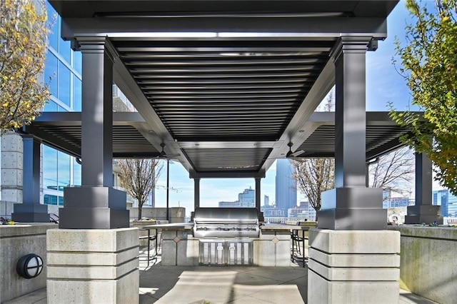 view of patio featuring exterior kitchen, grilling area, and a city view