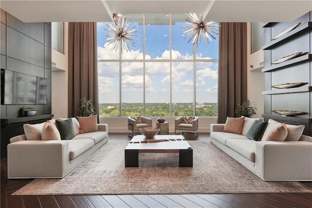 living room featuring a chandelier, plenty of natural light, and hardwood / wood-style flooring