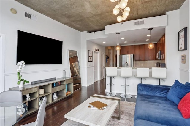 living area featuring dark wood-style floors and a chandelier