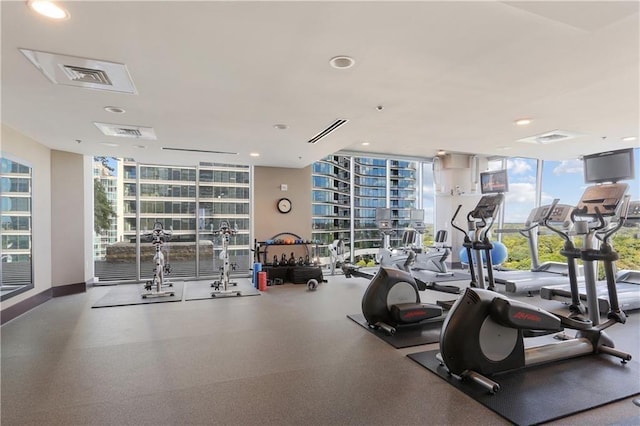 workout area featuring a wall of windows and recessed lighting
