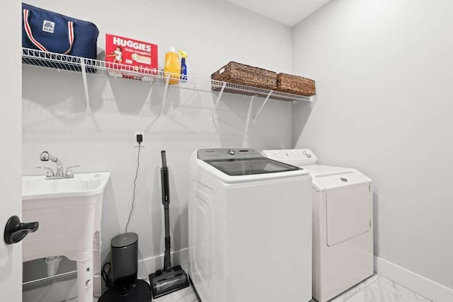 laundry room featuring sink and washing machine and clothes dryer