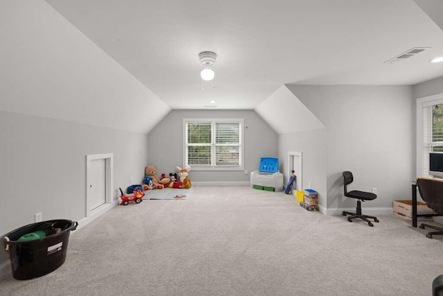 rec room featuring vaulted ceiling, light carpet, and a healthy amount of sunlight