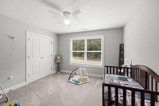 carpeted bedroom with ceiling fan and a closet