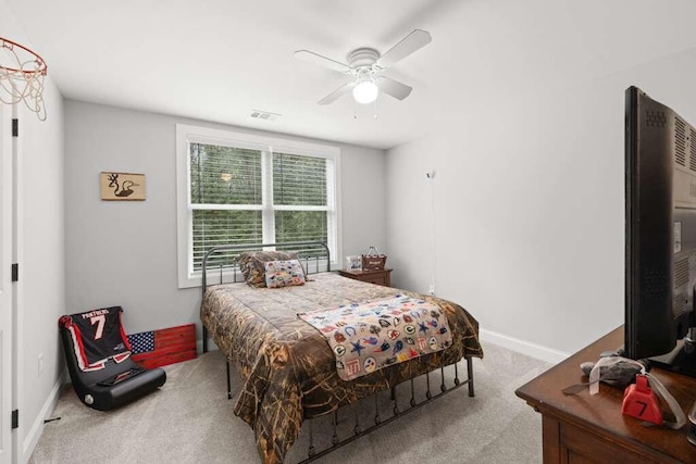 bedroom with ceiling fan and light carpet