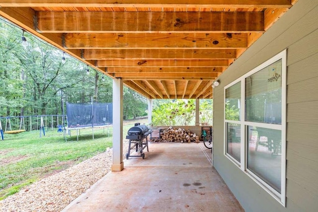 view of patio / terrace with area for grilling and a trampoline