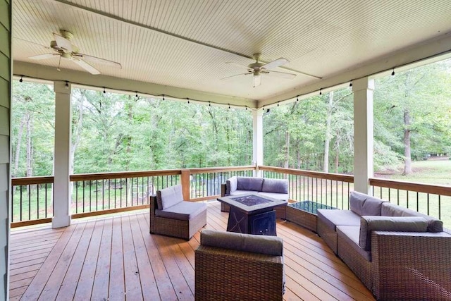 deck featuring an outdoor living space with a fire pit and ceiling fan