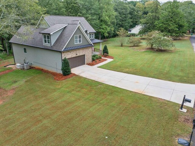 view of front of house with a garage and a front lawn