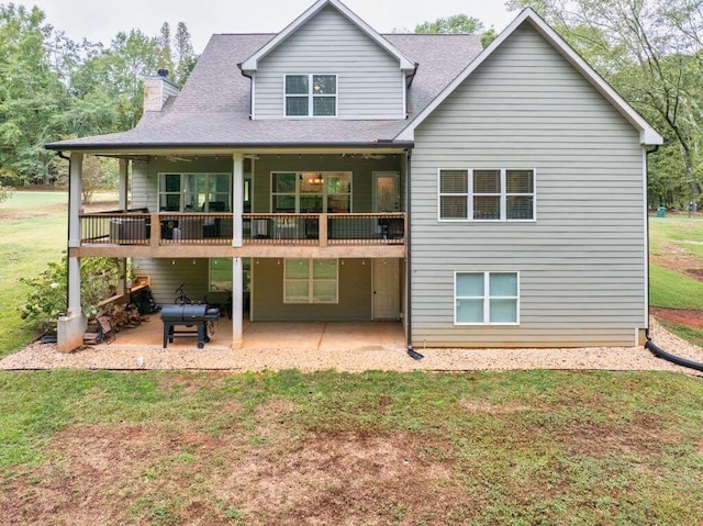 rear view of property with a yard and a patio area