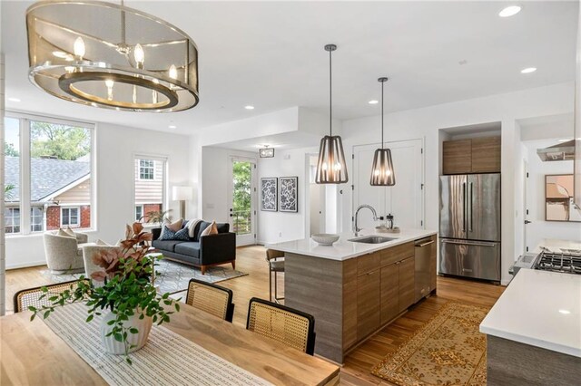 dining space featuring recessed lighting, light wood-type flooring, and a notable chandelier