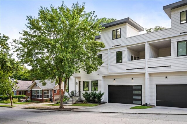 view of property with driveway and a garage