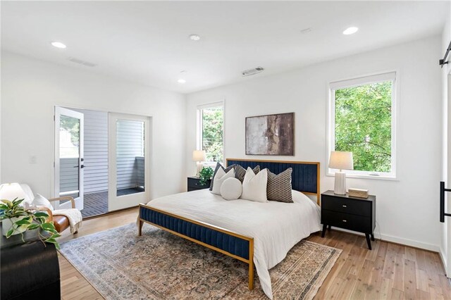bedroom with access to exterior, recessed lighting, baseboards, light wood-type flooring, and visible vents