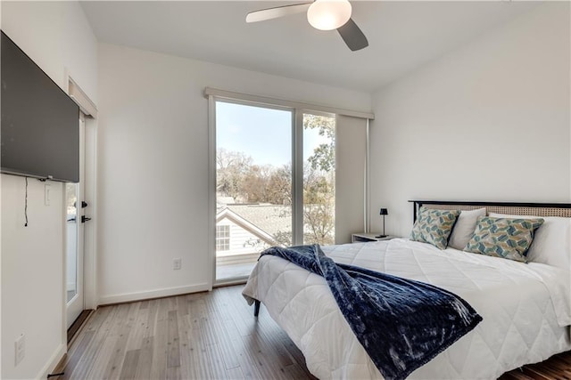 bedroom featuring baseboards, a ceiling fan, and wood finished floors