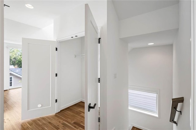 hallway with recessed lighting, baseboards, and wood finished floors