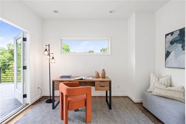 home office with baseboards and wood finished floors