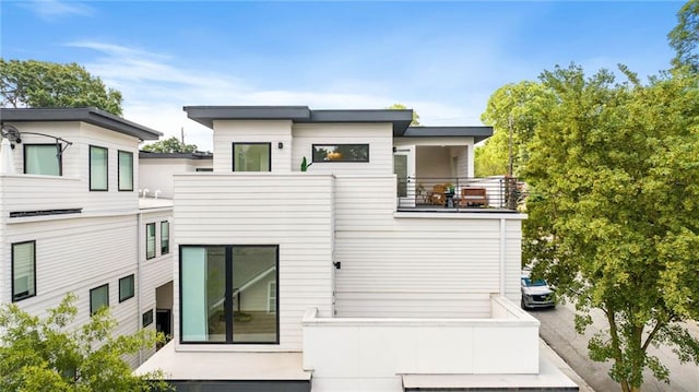 back of house with a balcony